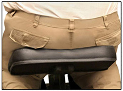 A cropped image of a person seated on an Apollo massage chair showing a wider seat width vs. a normal seat width