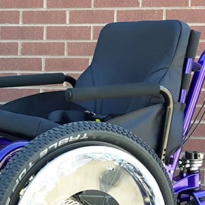 An image of the high seatback of the Mountain Trike Off Road Wheelchair on brick background