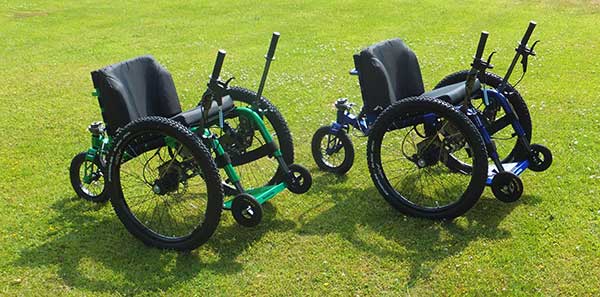 Green and Blue Mountain Trike Wheelchairs on grass