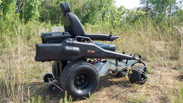 The Outdoor Extreme Mobility Nomad wheelchair with accessories parked on dry grass