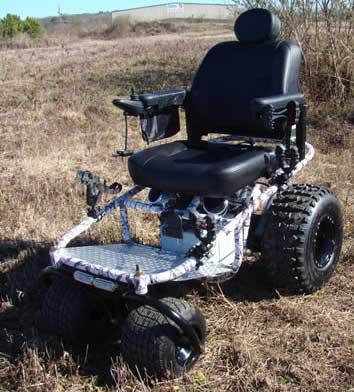 Outdoor Extreme Mobility Nomad All Terrain Power Wheelchair facing left on dry grass