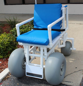 The Rolleez All Terrain Beach Wheelchair with seat belt in an outdoor setting