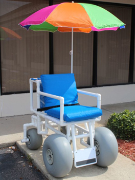 The Rolleez Beach Wheelchair with umbrella in an outdoor setting 