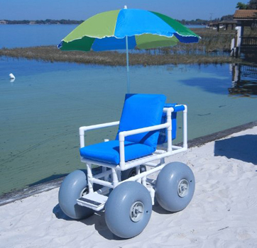 An image of the Rolleez All Terrain Beach Wheelchair with umbrella in the beach