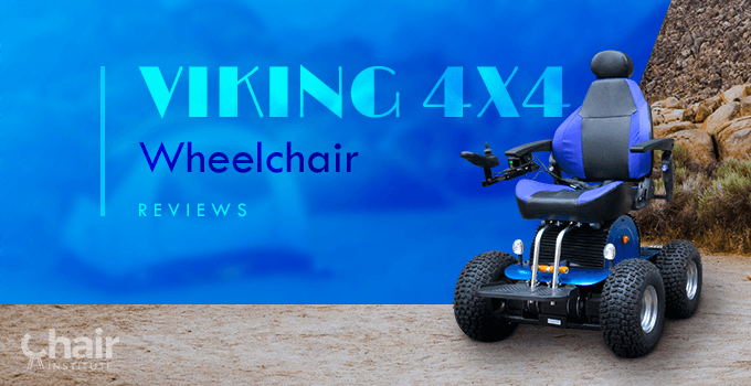 The Viking 4x4 Wheelchair on a Sandy terrain with a tent and boulders in the background