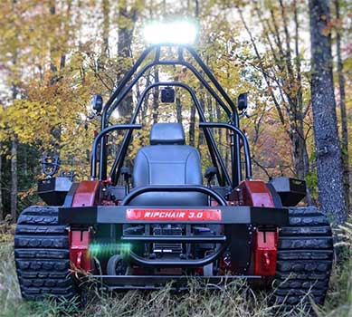 Front view of the Ripchair 3.0 Track Chair with trees in the background