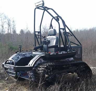 Left side view of the Ripchair 3.0 track chair in a jungle terrain