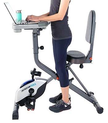 An image showing that a girl stands with Exerpeutic ExerWork 2000i Folding Bike Desk 