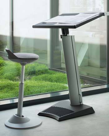 An image of Via Muvman Sit-Stand Stool in grey color in a beautiful office environment