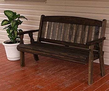 CAF Amish Bench on a beautiful patio next to a plant.