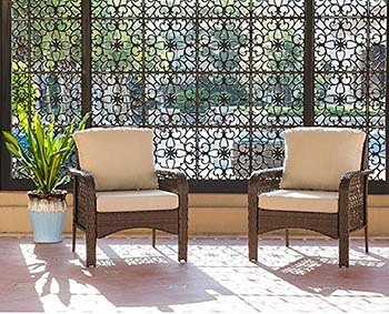 Two chairs of the Ovios 4 Piece Rattan Furniture with beige cushions
