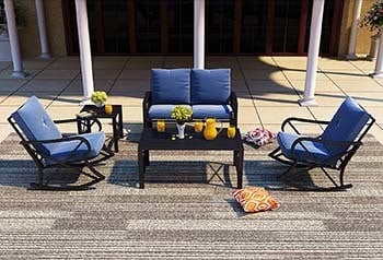 Blue variant of the Patio Festival 5 Piece Patio Conversation Set with flowers on a vase and drinks on its tables