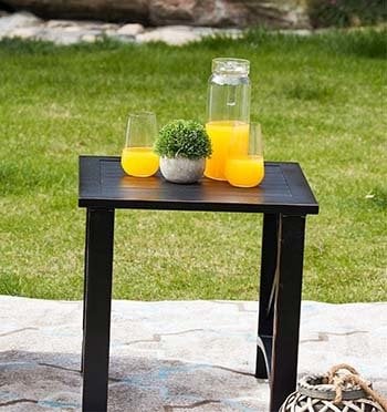 Side table of the Patio Festival 5-Piece Metal Patio Conversation Set with a plant decor and refreshing drinks on it