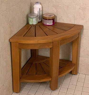 The Rose Home Fashion Teak Corner Shower Bench placed in the corner of a shower area