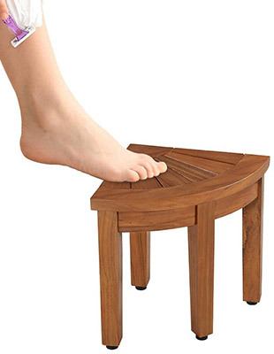 A leg being shaved with the foot on the Rose Home Fashion Teak Shower Foot Stool