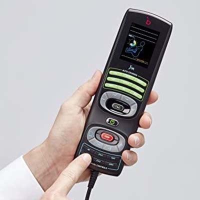 Jin's old school wired remote control with a small screen and buttons, and a person holding it and pointing at the controls