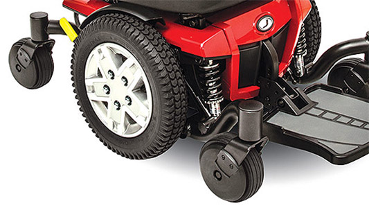 Jazzy 600ES Power Chair's mid-wheel drive with black flat-free tires, adjustable foot platform, and glossy red base
