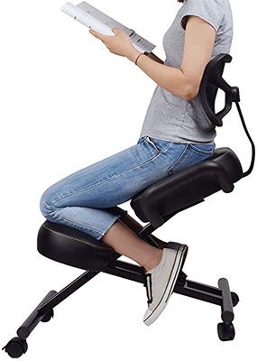 Woman reading a book and sitting on a black VIVO Kneeling Chair with breathable back support, thick cushions, and casters