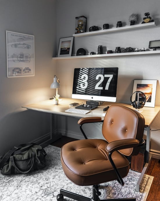 Brown leather swivel office chair in a home office setting